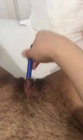 Arabic slut fingering herself with a pen